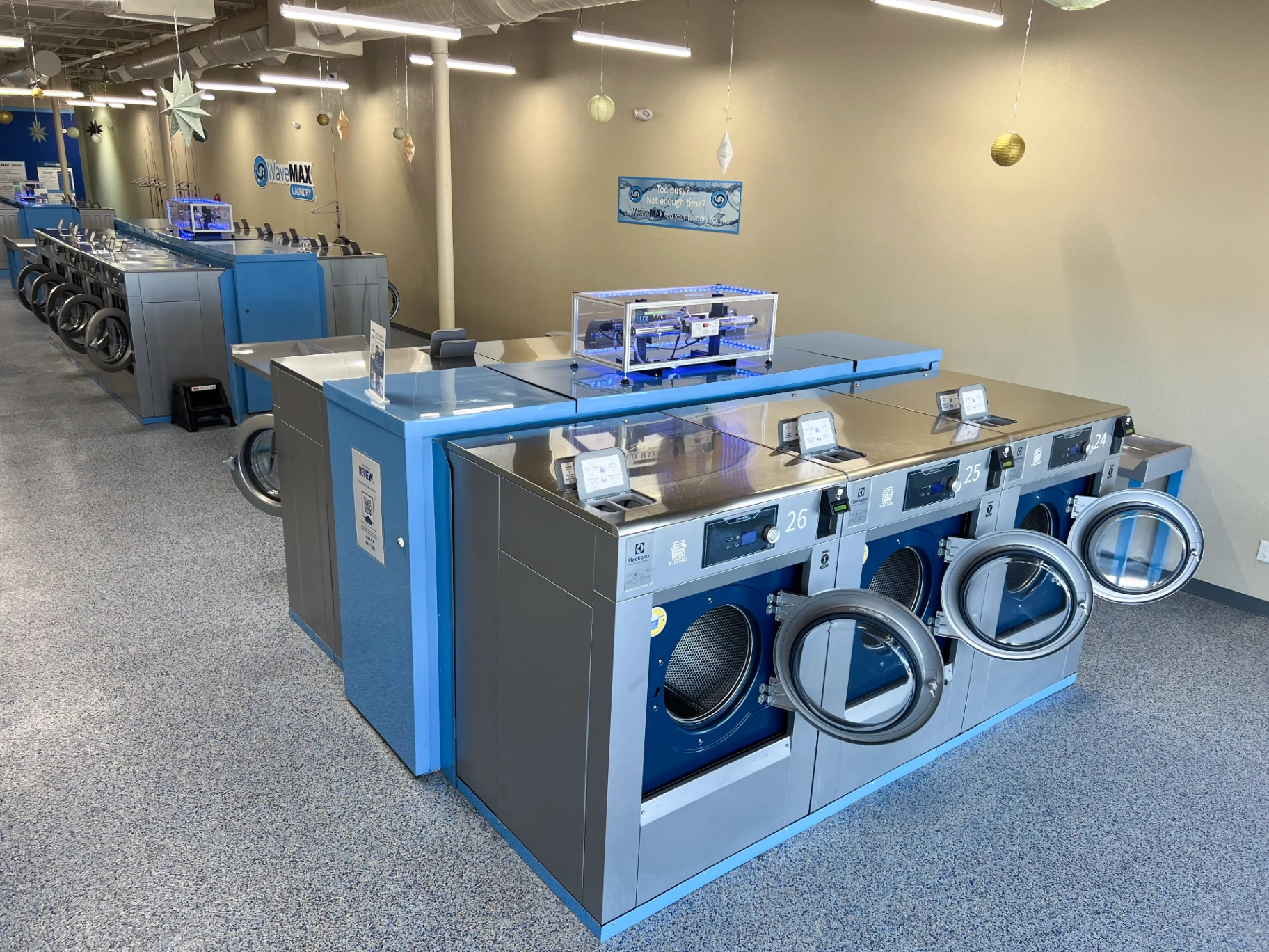 LUX UV sanitation system mounted above the commercial washers at WaveMAX Fort Worth