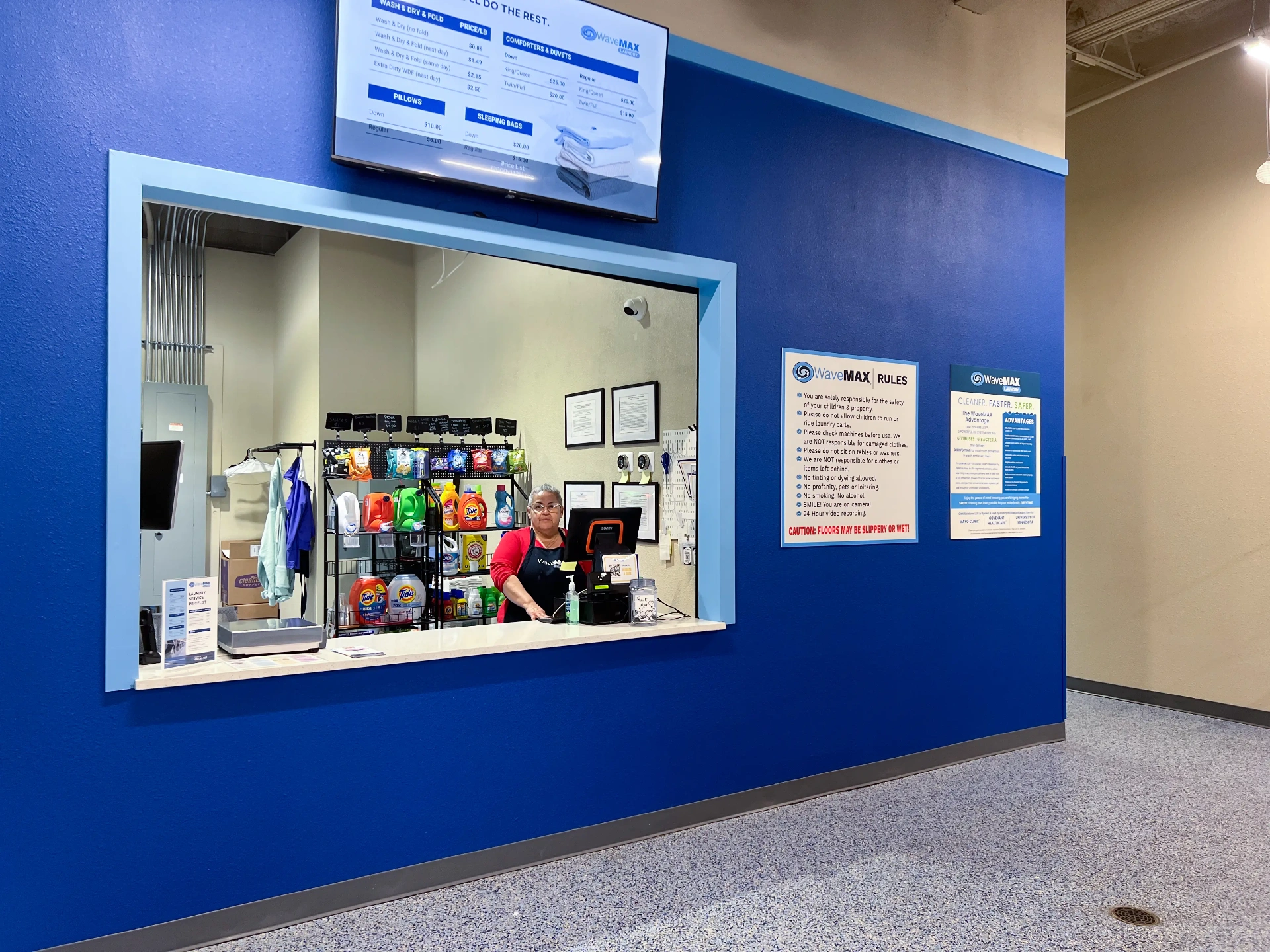 Friendly attendant at the WaveMAX Fort Worth wash and fold drop-off counter