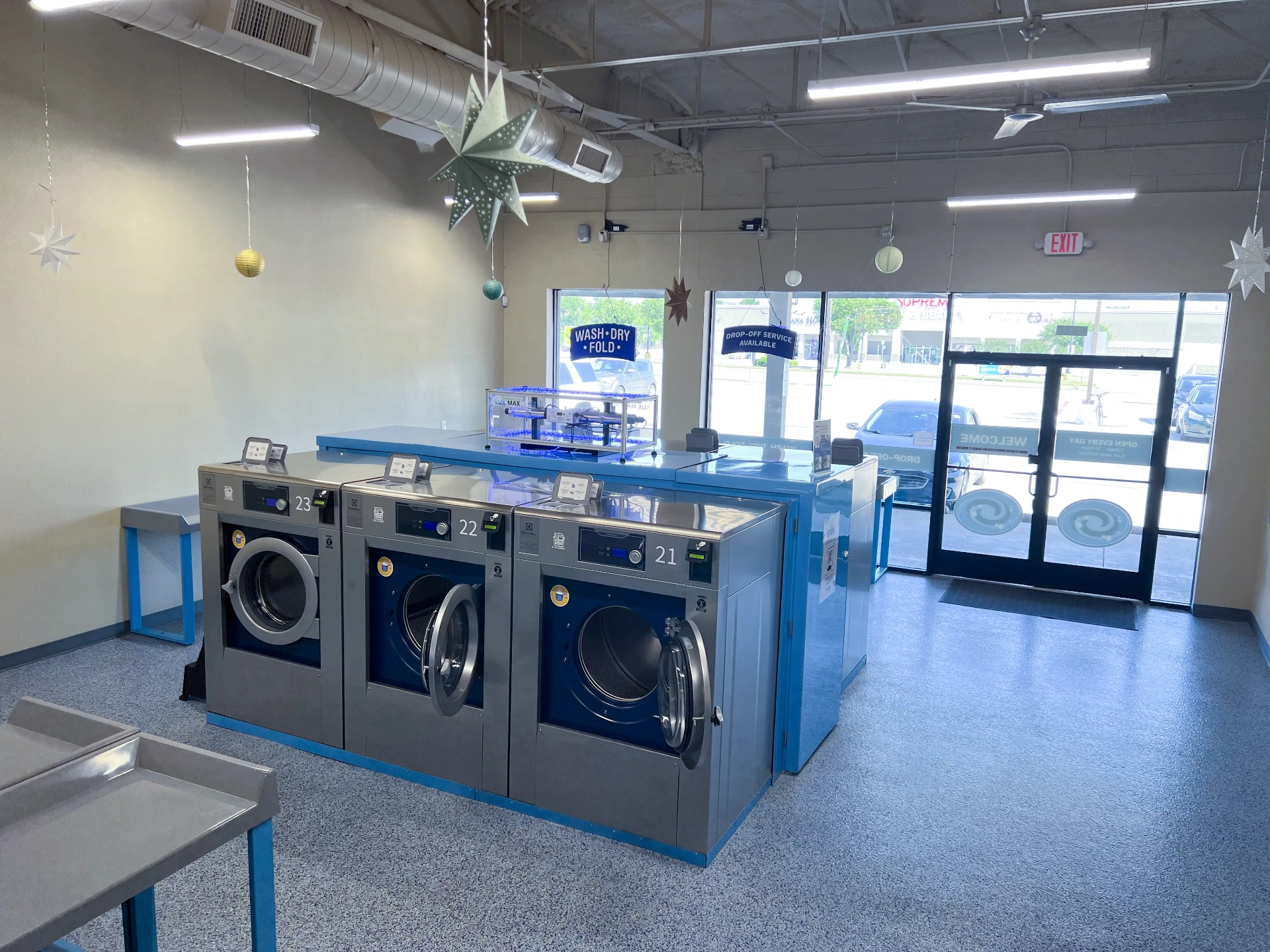 Brand-new Electrolux commercial washers with WASH·DRY·FOLD signage inside WaveMAX Fort Worth