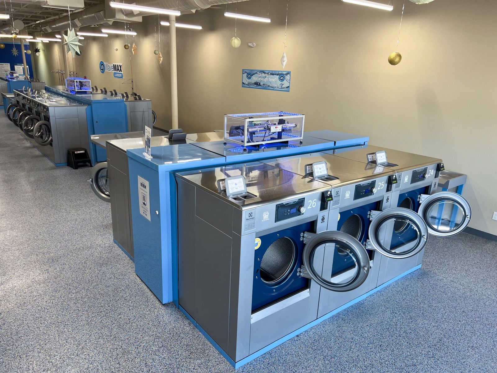 Close-up of the LUX UV sanitation system mounted above the washers